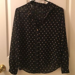 a sheer polkadot button up shirt.