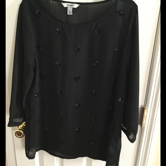 Long sleeved sheer top with sequin rosettes.