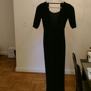 Long black figure hugging dress with exposed back
