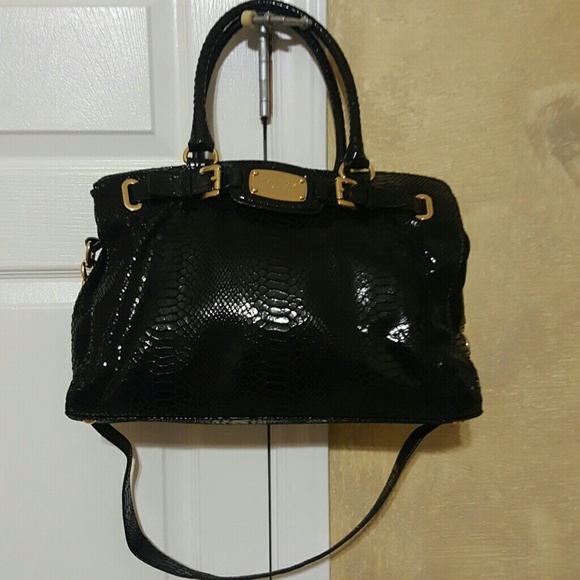 Black snake-like Michael Michael Kors handbag.