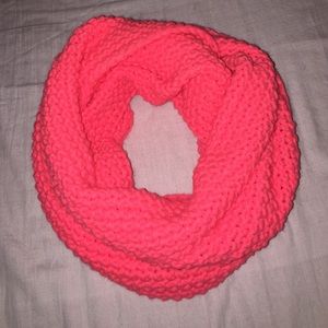 Neon pink knitted scarf.