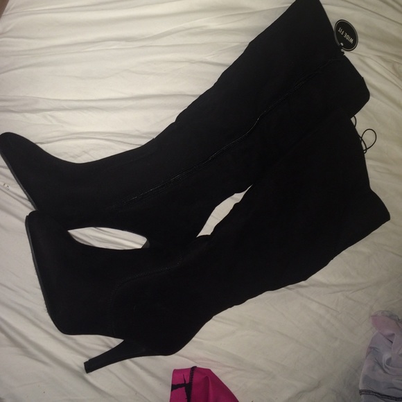 These are black high heel boots.