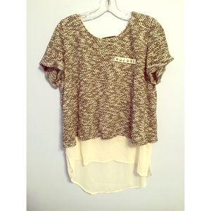 Knit top with sheer underlay.
