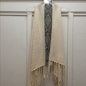 Long, layering, sleeveless cardigan.