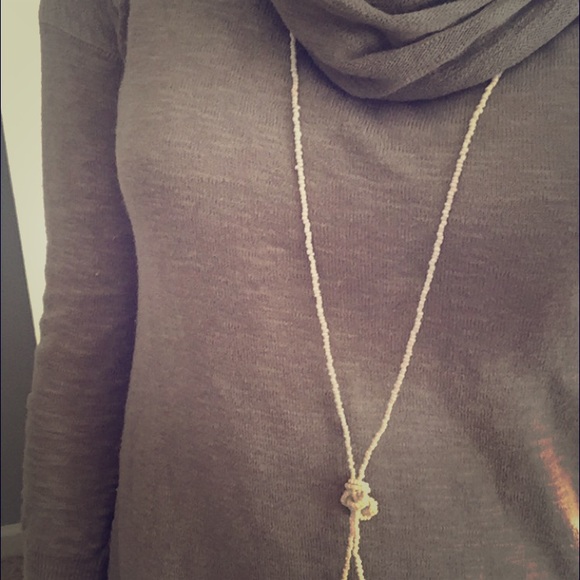 Long cream beaded necklace knot