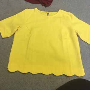 A yellow shirt with scalloped bottom.