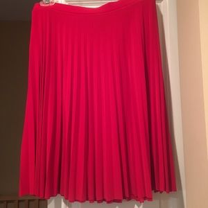 A red pleated knee length skirt