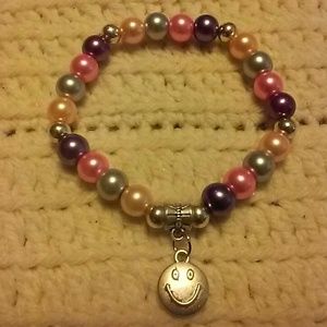 Multi color pearl and smiley face charm bracelet