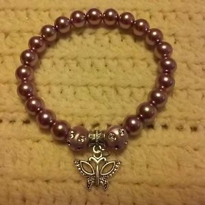 Purple beaded bracelet with butterfly charm