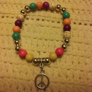 Multi color bead bracelet with peace sign charm