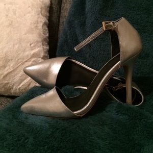Silver Aldo pumps with ankle strap.