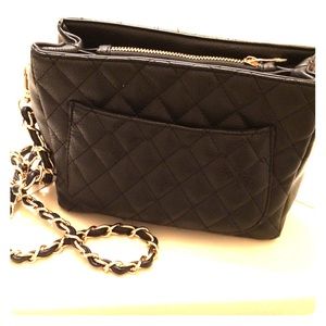 Black quilted purse with gold shoulder strap