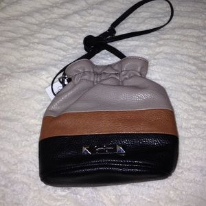 Drawstring multi colored cross-body bag.