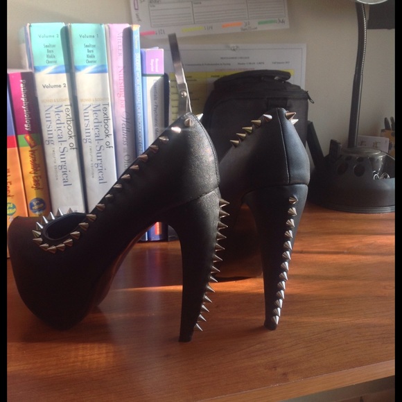 Spiked black pumps we unique heel design.