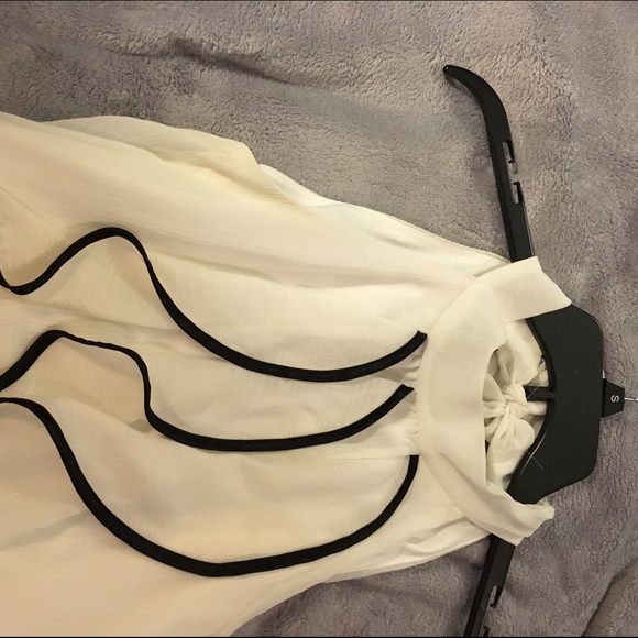 Tank top blouse with black trim detail.