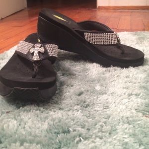 Volatile rhinestone cross flip flops