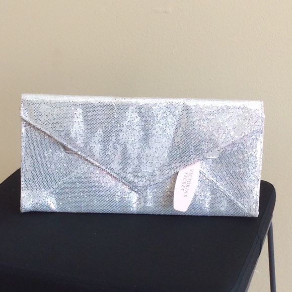 A silver sequined Victoria Secret clutch.