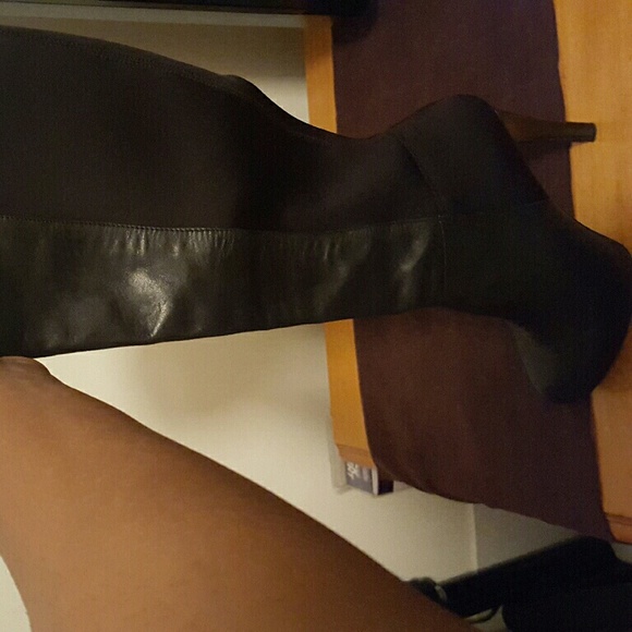 Black knee high heel boots.