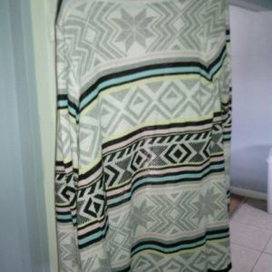 Long colorful cardigan gently worn.