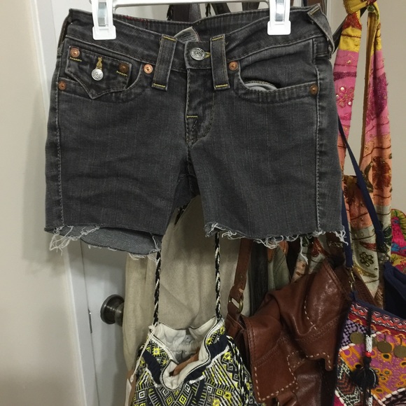 Grey true religion shorts with yellow stitching.
