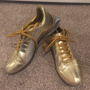 Gold and silver Puma Runners