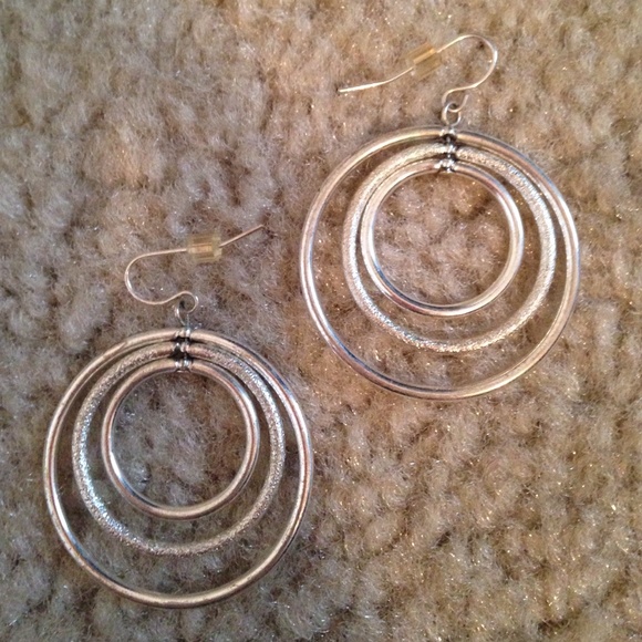 Layered silver loop earrings.