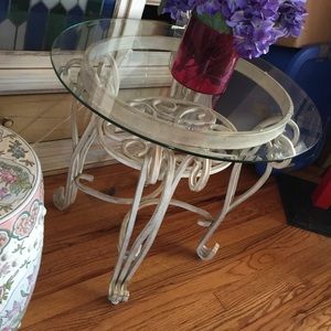 there are two glass topped tables