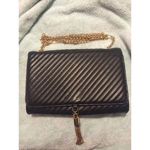 Black satchel with gold accents