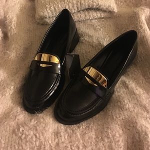 Black fashion loafers with a splash of gold