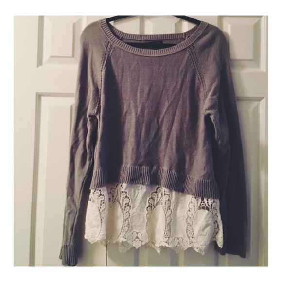 Grey sweater with lace hem.
