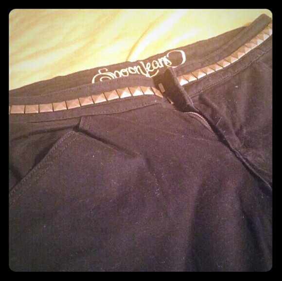 Black flares with gold studs around waist
