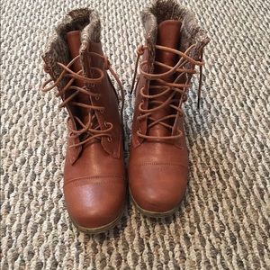 Brown combat boots with a zipper accent.