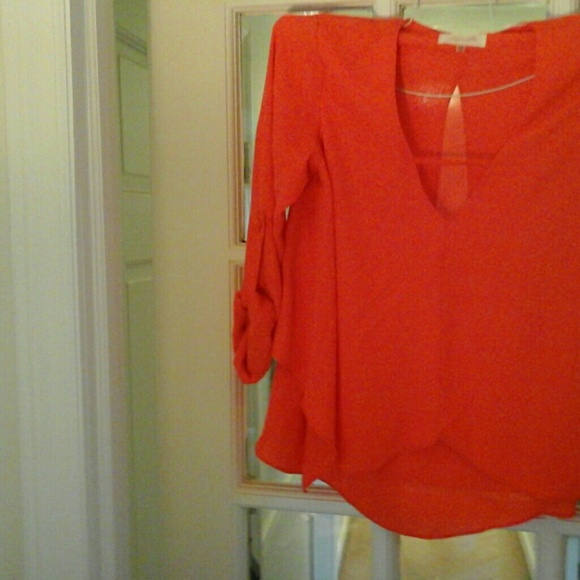 Deep orange crepe short flare bottom blouse.