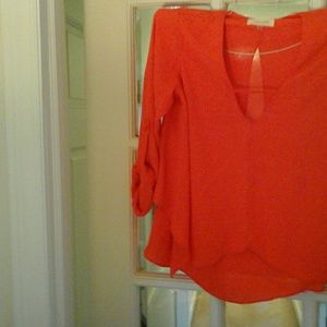 Deep orange crepe short flare bottom blouse.