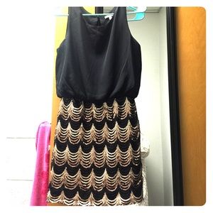 Black cocktail tank strap dress with sequin skirt