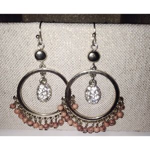 Gold hoop earrings with stone detail.