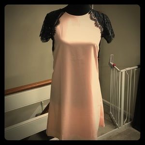 Pale pink dress with black lace sleeves
