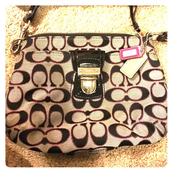 Small over the shoulder coach purse.