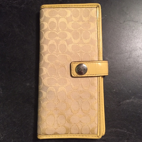 Coach Slim Signature yellow wallet.