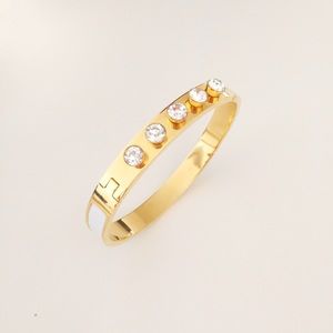 Gold and diamond bracelet with leather accent