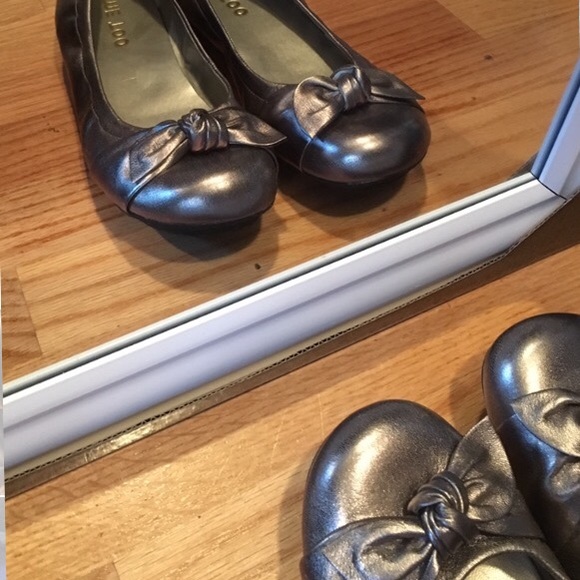 Grey / silver flats with a bow & short heel