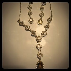 Silver necklace and earrings.