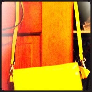 Highlighter yellow cross body bag with tassel.