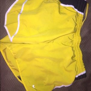 Yellow Nike running shorts