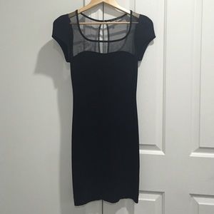 Black tight dress with a sheer top.
