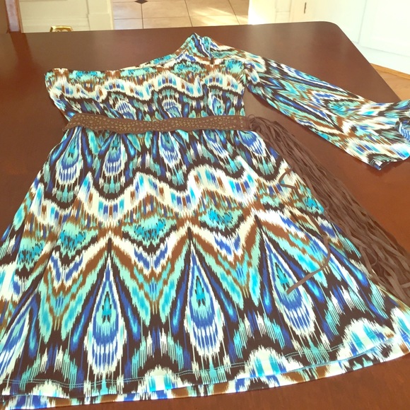 A colorful one shoulder dress with fringe belt