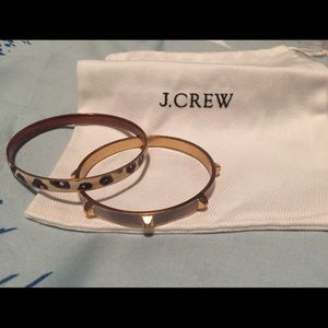 J. Crew bangles. One is gold studded and lilac.