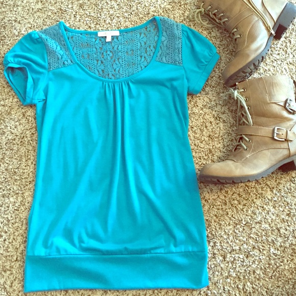 Delia's blue top with lace shoulders and back
