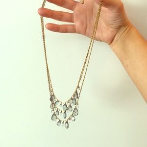 Triple chain gold necklace with gems