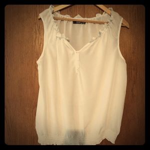 White sleeveless blouse.